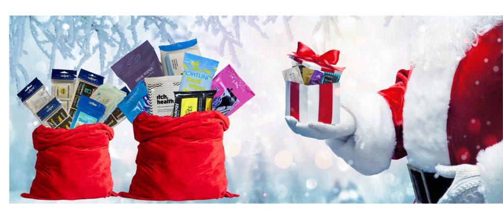 A picture of Santa delivering gifts and sacks full of wipe and sachet product gifts.